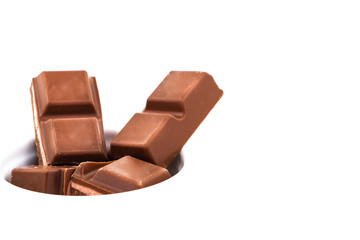 dark chocolate is poured onto a piece of chocolate with a filling