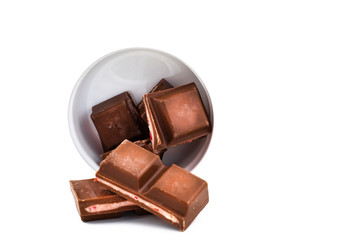 dark chocolate is poured onto a piece of chocolate with a filling