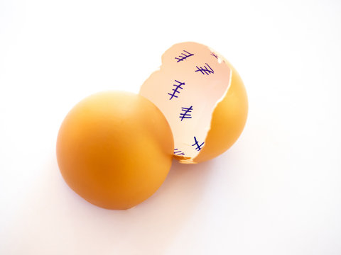 A broken egg with a countdown inside it and feather on a pastel blue background. Concept of freedom