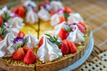 Delicious lemon tarts and garnished with strawberry, cooking dessert..