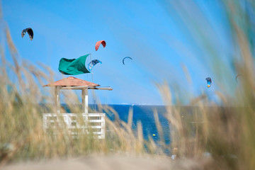 beach tower kites with green flag.