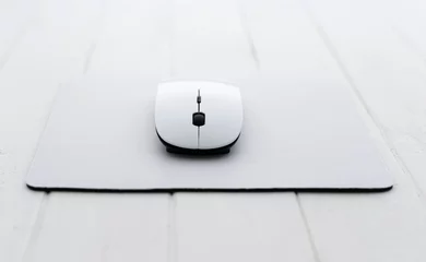 Foto op Canvas White wireless mouse on a mouse pad © Ievgen Skrypko