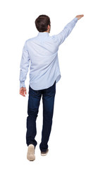 Back view of a man walking with a pointing hand.