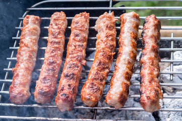 Grilling. Cooking barbecue with charcoal in the garden. T