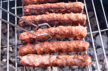 Grilling. Cooking barbecue with charcoal in the garden. T