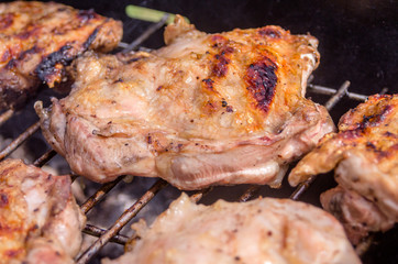 Obraz na płótnie Canvas Chicken steak on the grill. Cooking chicken on the barbeque with charcoal in garden.