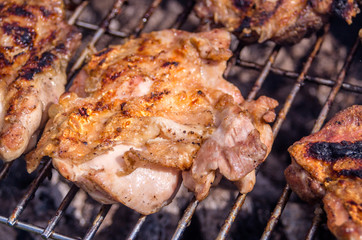 Chicken steak on the grill. Cooking chicken on the barbeque with charcoal in garden.