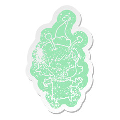 cute alien girl cartoon distressed sticker of a wearing santa hat