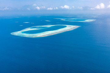 Naklejka na ściany i meble Aerial view of Maldives atolls is the world top beauty. Maldives tourism. Exotic aerial landscape in Maldives islands