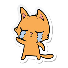 sticker of a crying cartoon cat pointing