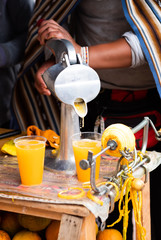 Juice making tool with orange and glasses on the table