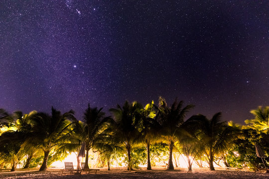 Milky Way galaxy rise above Maldives island. Long exposure photograph with grain
