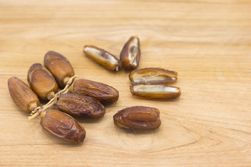 Close up fruits of date palm on wood background,fresh date-palm and dry date-palm on rustic wooden 