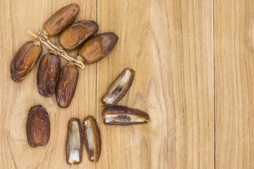 Close up fruits of date palm on wood background,fresh date-palm and dry date-palm on rustic wooden 