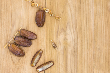 Close up fruits of date palm on wood background,fresh date-palm and dry date-palm on rustic wooden 