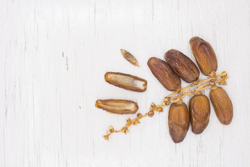 Close up fruits of date palm on wood background,fresh date-palm and dry date-palm on rustic wooden 