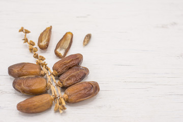 Close up fruits of date palm on wood background,fresh date-palm and dry date-palm on rustic wooden 