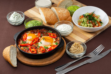 shakshuka in the pan and food on a table