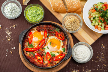shakshuka in the pan and food on a table