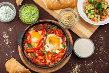 shakshuka in the pan and food on a table