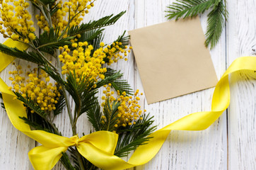 Easter eggs and Mimosa flower on a wooden background. Space for text. - Image