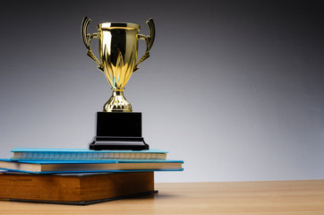 golden trophy on stack of book for education success concept.