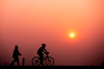 ride bicycle with sunset background.