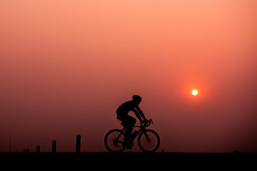 ride bicycle with sunset background.