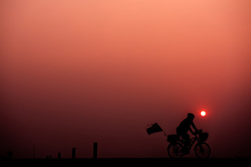 Obraz premium ride bicycle with sunset background.