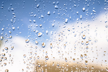 Beautiful raindrops on the window glass. Spring summer weather with warm rain. Stock photo