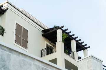 Balcony and window with wooden shutters in a European city