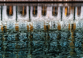 Reflection in the water of the gulf shimmers in green and orange colors
