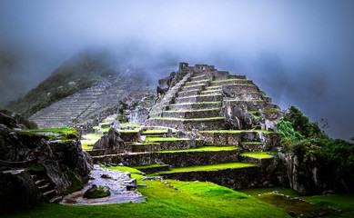 Amazing view of breathtaking Machupicchu temple covered with fog