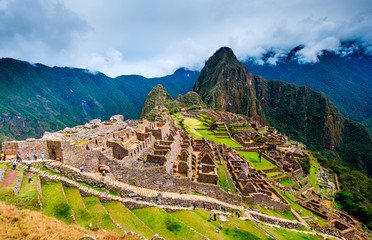 Breathtaking sunshine landscape of ancient majestic Machupicchu city among high rocky mountains...