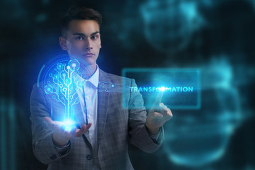 The concept of business, technology, the Internet and the network. A young entrepreneur working on a virtual screen of the future and sees the inscription: Transformation