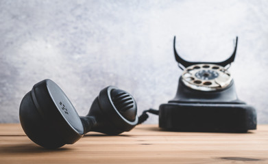 Old vintage telephone with the handset off