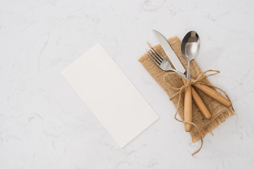 Concept of simple organic food - laconic design cutlery set on rustic wooden table and linen...