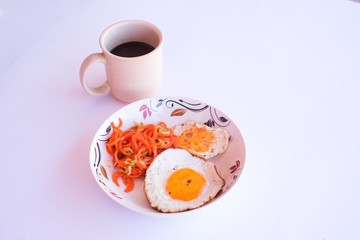 A set of healthy food, fried egg, minced carrot and a blackberry juice.