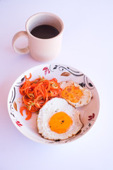 A set of healthy food, fried egg, minced carrot and a blackberry juice.