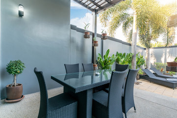 exterior design outdoor dining table and chairs on swimming pool terrace of the house or home building 