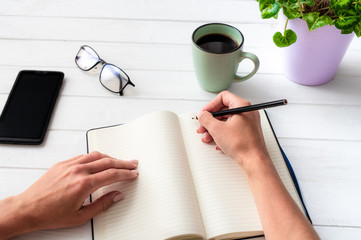 Top view of girl with notebook with background composition on white table