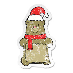 distressed sticker of a cartoon bear wearing christmas hat