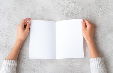 Girl' hands with molded sheet of paper