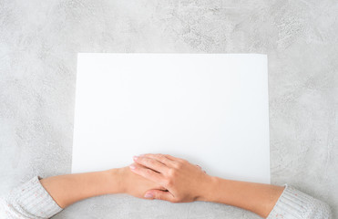 Girl put hands together on paper sheet