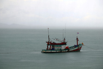 Fishing boat on the sea in the rain, Thailand