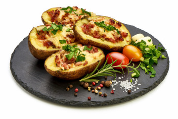 Hot Baked stuffed Potatoes with cheese, bacon, parsley, close-up, isolated on white background