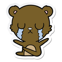 sticker of a crying cartoon bear