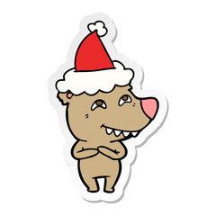 sticker cartoon of a bear showing teeth wearing santa hat