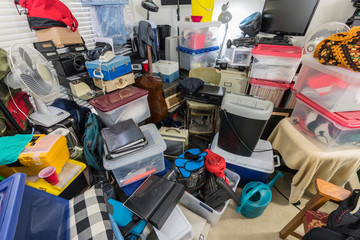 Hoarder room packed with storage boxes, old electronics, files, business equipment and household...