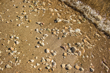 sand stone beach shoreline nature background surface from above near wave photography 